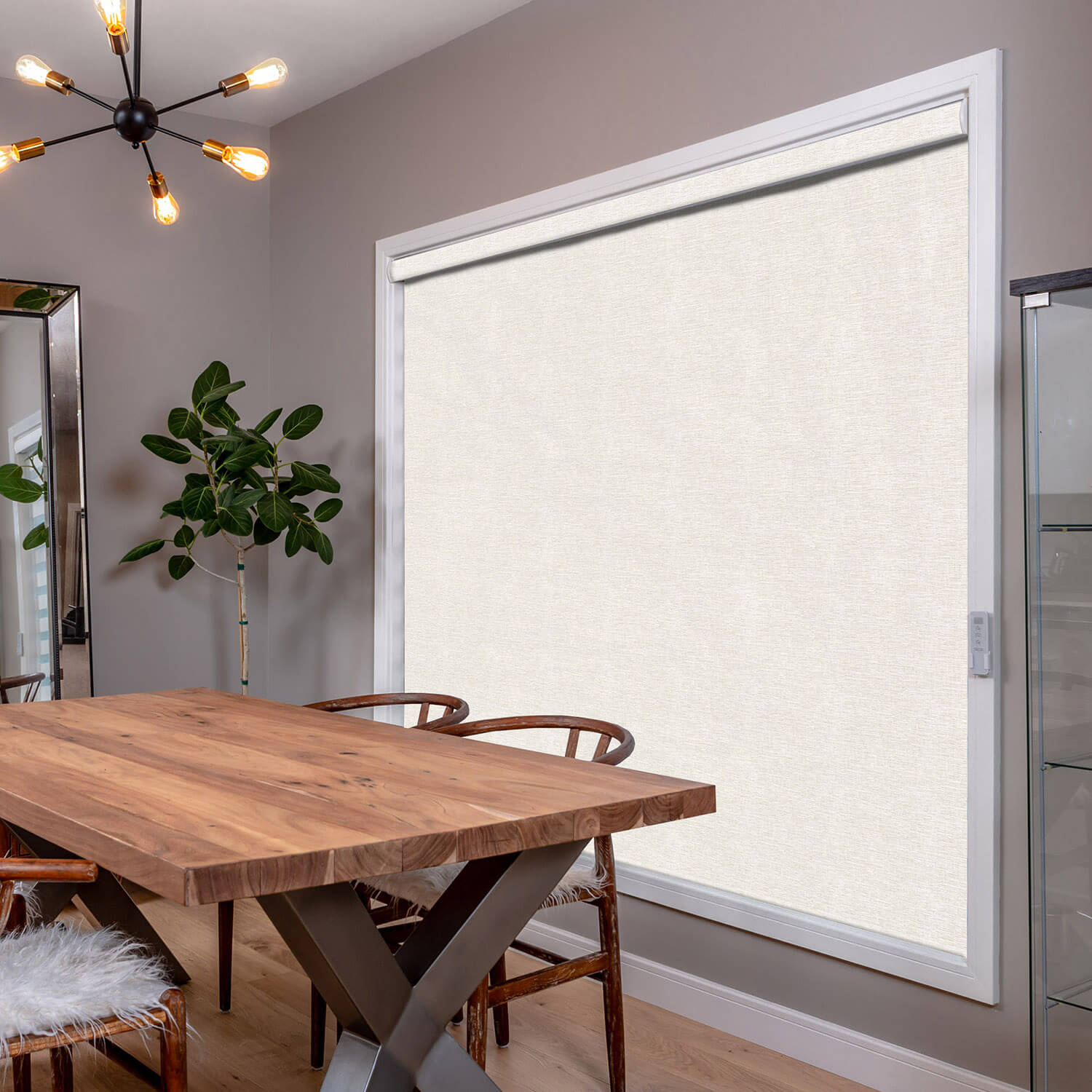 A large roller shade covering a floor-to-ceiling window in an open space