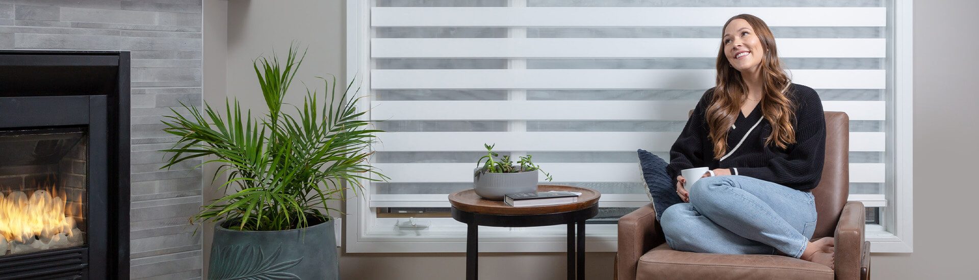 happy woman on chair with zebra blinds with motorization